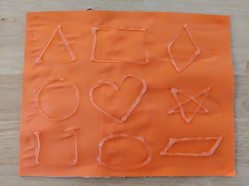 Make a touch and feel shapes board to learn shapes with the sense of touch! Outline shapes with hot glue on a sturdy background.