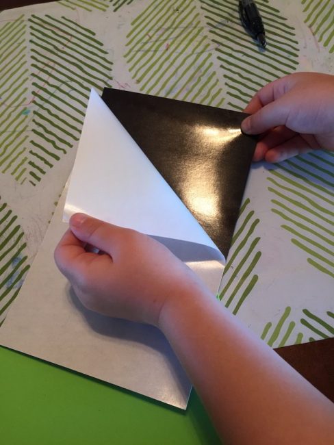 Peel the paper off the magnet - it's great for fine motor skills!