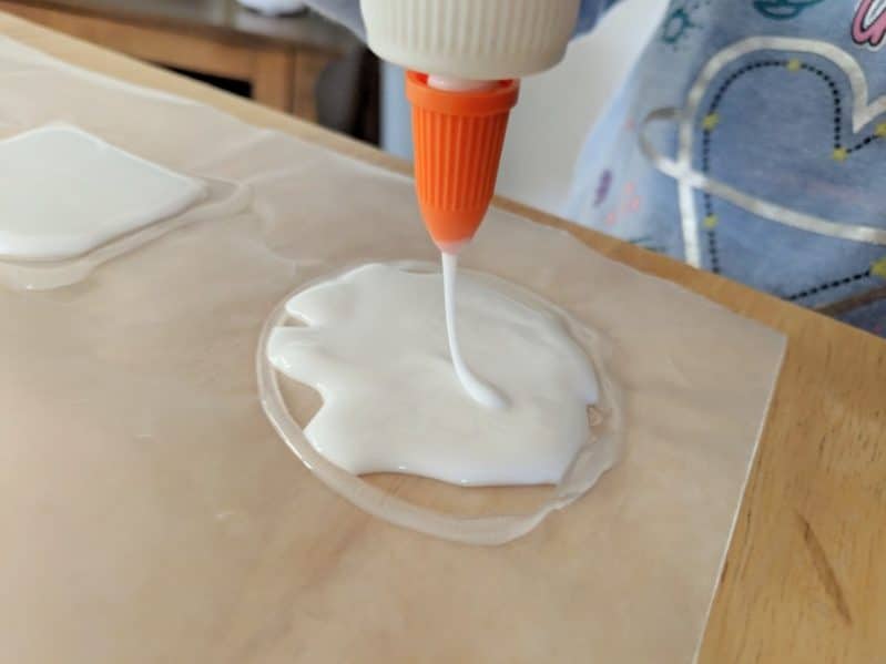 A little (or a lot) of school glue creates the base for your charm necklace craft!