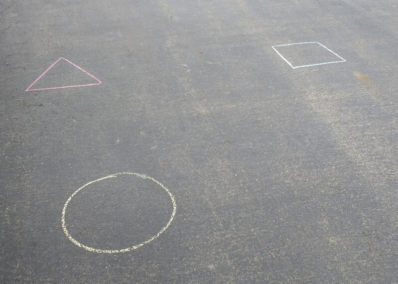 Set up a water balloon shape matching activity in the driveway