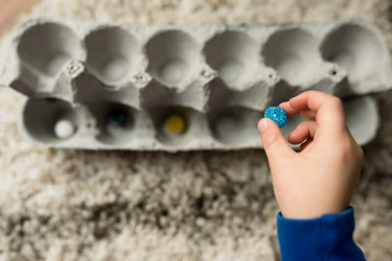 Challenge your child to set the little objects back into the tray without peeking!