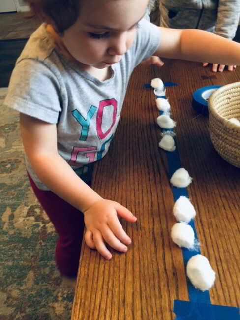 Count and squish on a fun cotton ball lineup game for toddlers!