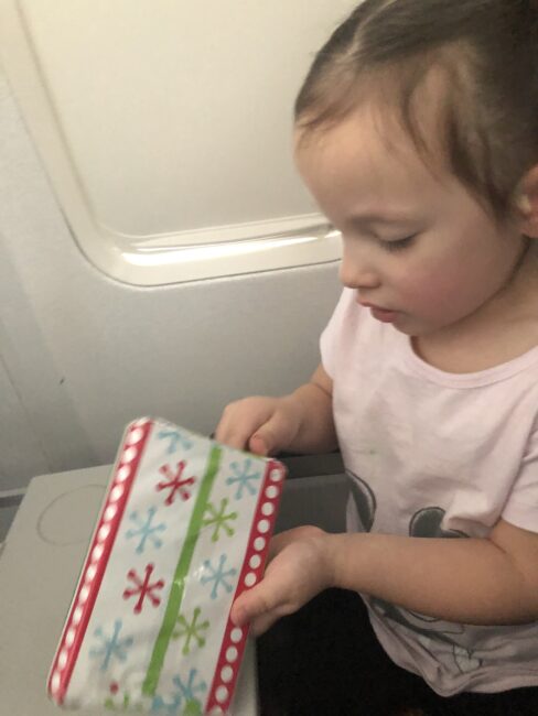 Wrap small presents for your child to unwrap on the plane. A sneaky way to work on fine motor skills while entertaining kids on a plan.