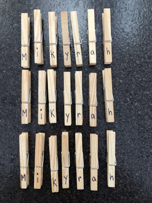Your child's name written on clothespins 3 times for letter match up game.