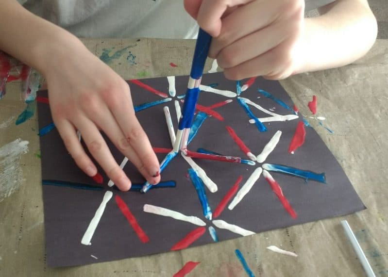 Painting fireworks using straws to stamp