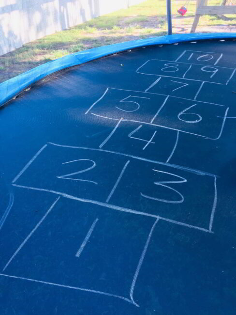 Setting up the trampoline hopscotch game for kids