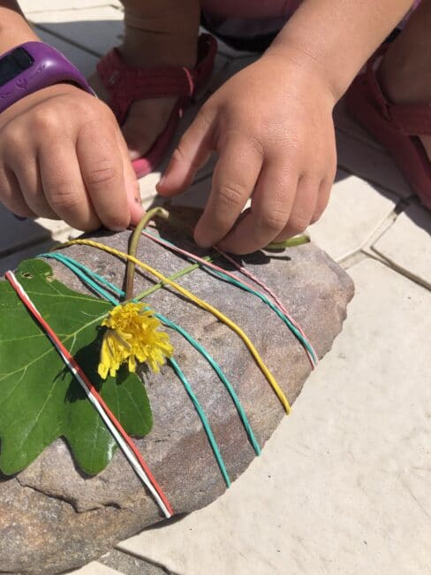Find nature items to weave into the elastics on your rock