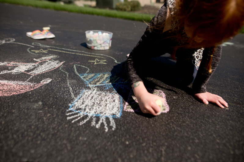 Adding presents into Santa's sleigh with chalk drawing