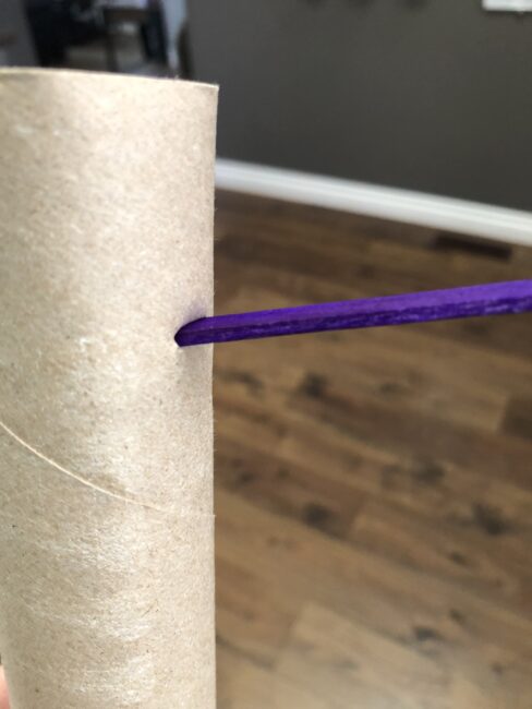 place popsicle sticks in slits all over the paper towel roll.
