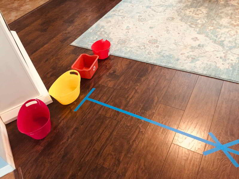 Try this fun balance beam toddler game to match colors and develop gross motor skills!
