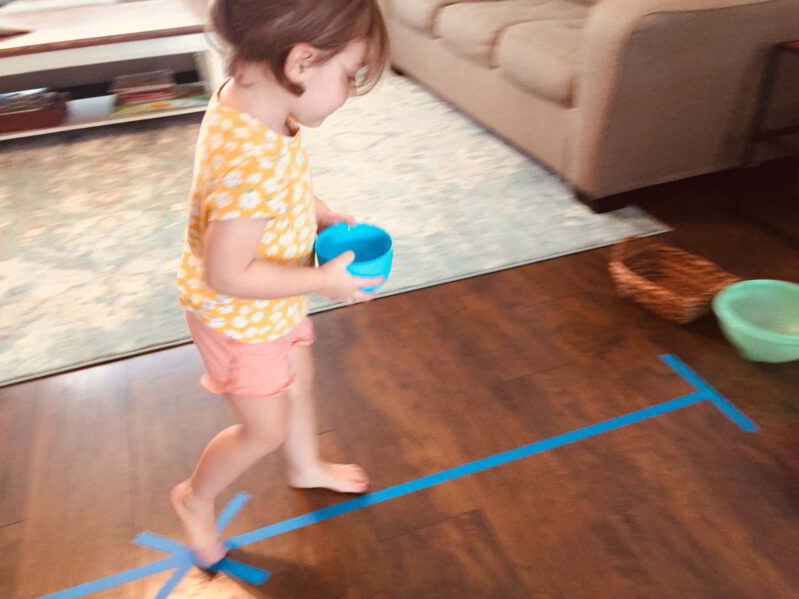 Try this fun balance beam toddler game to match colors and develop gross motor skills!