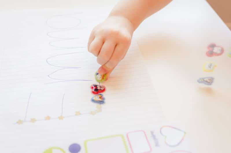 Have your toddler trace their name using stickers!