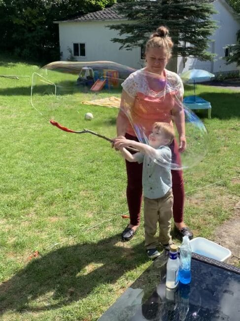Your kids will love making bubbles with these DIY giant bubble wands! Use supplies from around the house and have lots of gross motor fun.