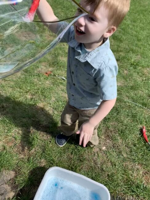 Your kids will love making bubbles with these DIY giant bubble wands! Use supplies from around the house and have lots of gross motor fun.