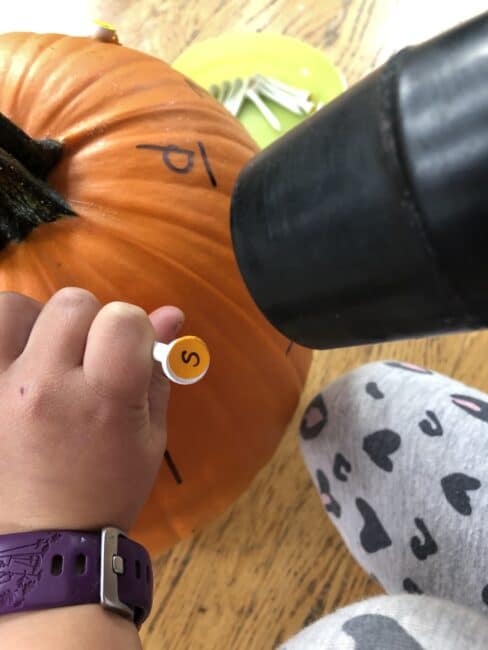 Super simple pumpkin hammering activity to teach letters through.