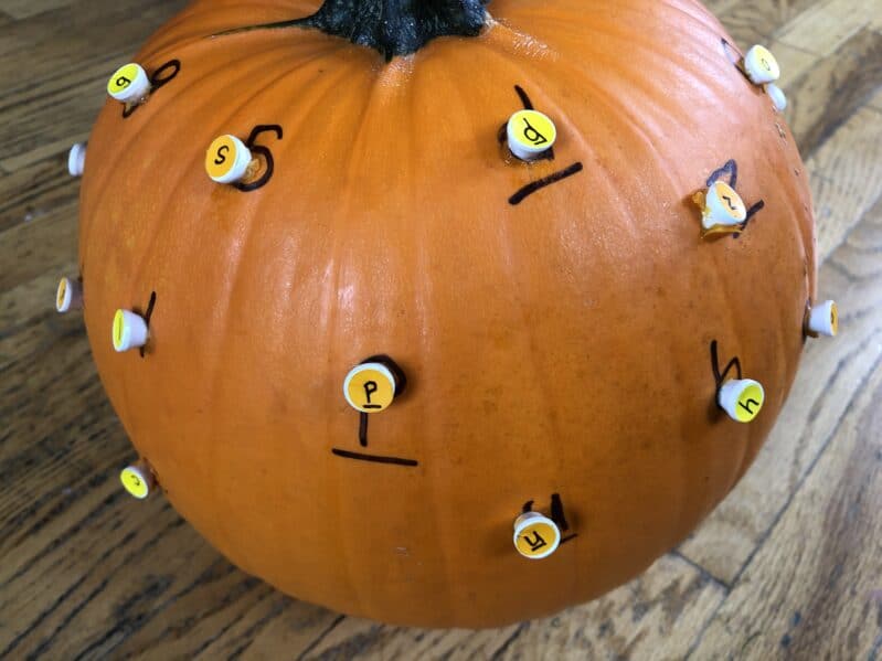 This is a super simple pumpkin hammering activity to teach letters through engaging fine motor fun for Fall.