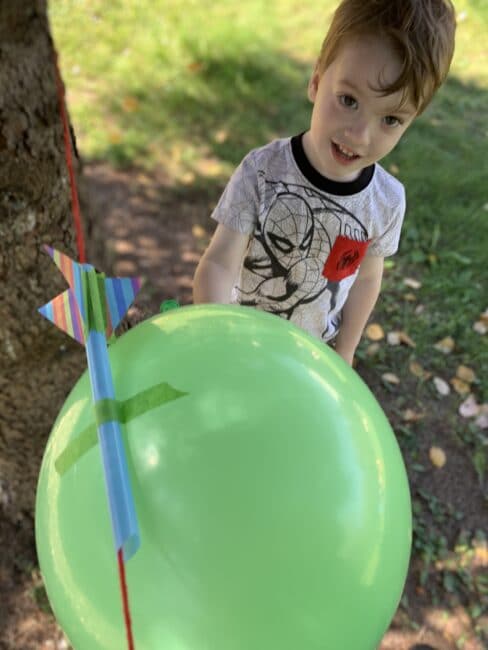 Super simple science experiment with vertical balloon straw rockets to teach kids about Newton’s third law of motion or simply have some fun!
