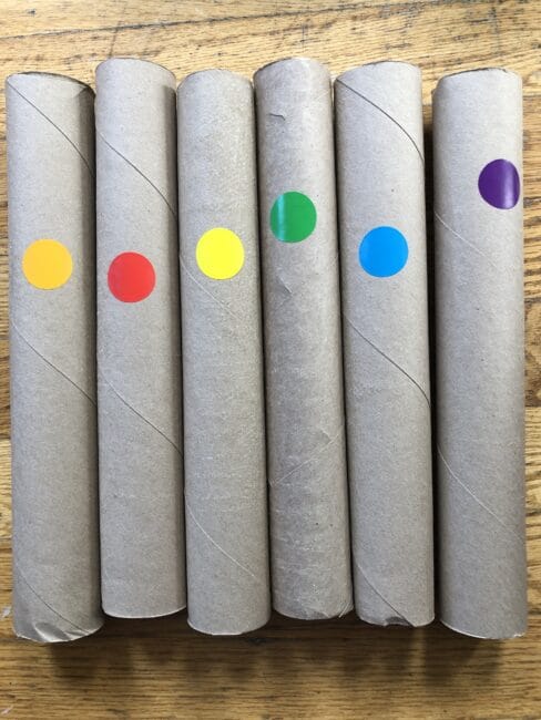 Preparing paper rolls for balancing colored balls on top.