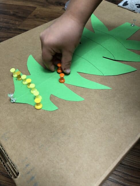 Use push pins to decorate a Christmas tree for fine motor skills and color sorting or patterns