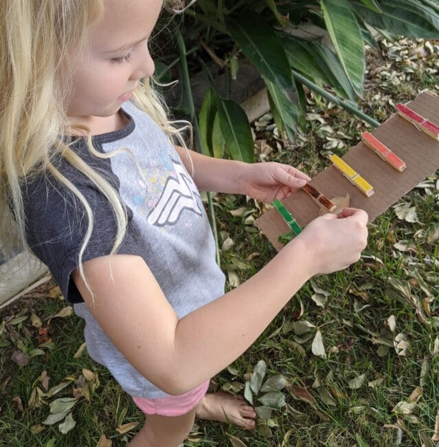 A simple and fun nature color scavenger hunt with clothespins activity for outdoor exploring, fine motor skills, and color learning for kids.