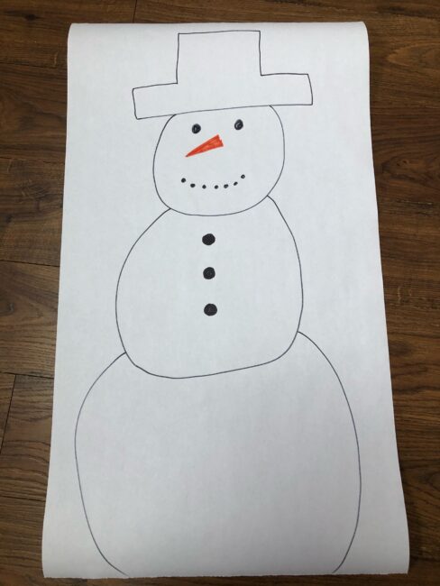 Draw a snowman on a large sheet of paper for snowman activity.