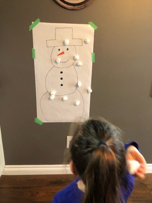 Gross motor indoor cotton ball snowman activity for toddlers and preschoolers.