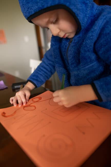 Paint with water tracing on construction paper activity for kids.