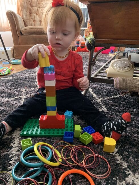 Super simple DIY ring stacking fine motor activities for toddlers using Lego blocks and bracelets.