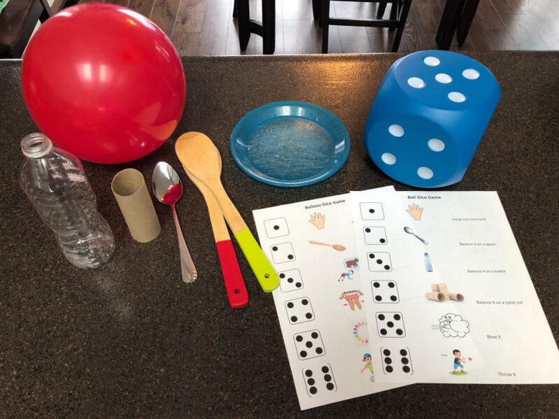 Supplies needed to create your own ball or balloon dice games at home for your kids.