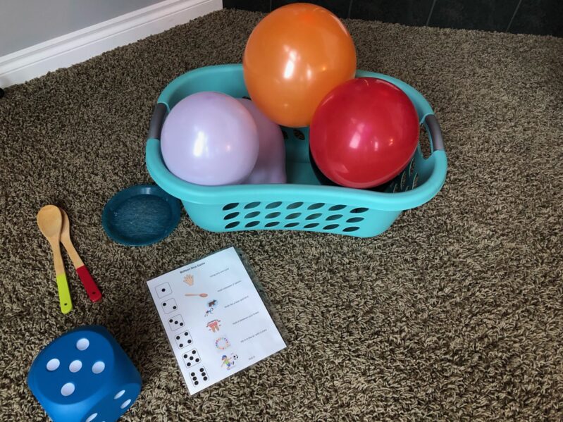Everything you need to play your own balloon and dice game for kids to get out energy.