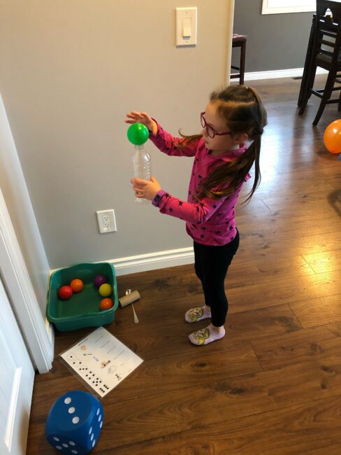 Get your kids moving in this fun and exciting dice game which practices multiple gross motor skills with balls indoors at home.