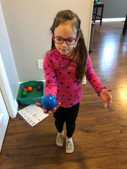 Get your kids moving in this fun and exciting dice game which practices multiple gross motor skills with balls indoors at home.