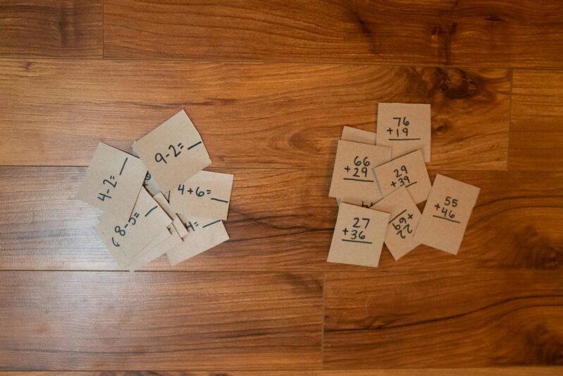 Write math problems on the pack of each piece appropriate for your child's age.