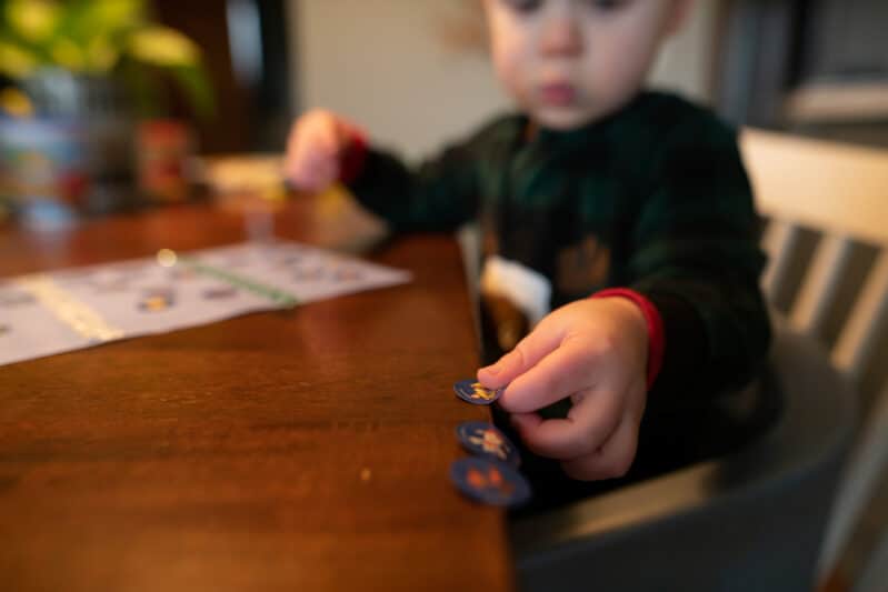Peel off stickers and line them up on the edge of table if your toddler is having trouble peeling them.