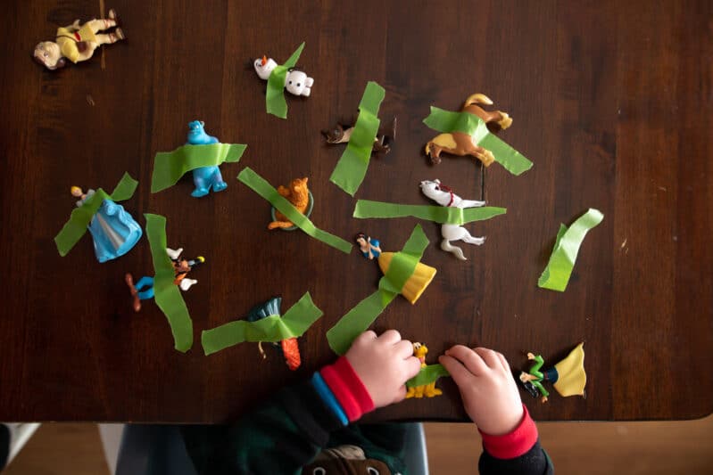 Rescue toy animals by pulling tape in this super simple fine motor activity that's perfect for toddlers and preschoolers both to do at home!