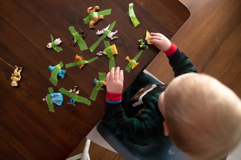 Rescue toy animals by pulling tape in this super simple fine motor activity that's perfect for toddlers and preschoolers both to do at home!