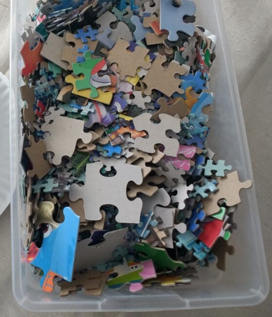 bucket full of puzzle pieces for crafts