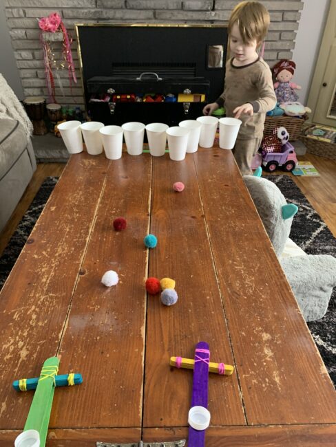 Quick and easy DIY homemade pom pom catapult activity for young kids with no glue or wait time! Put it together and start to play in minutes!