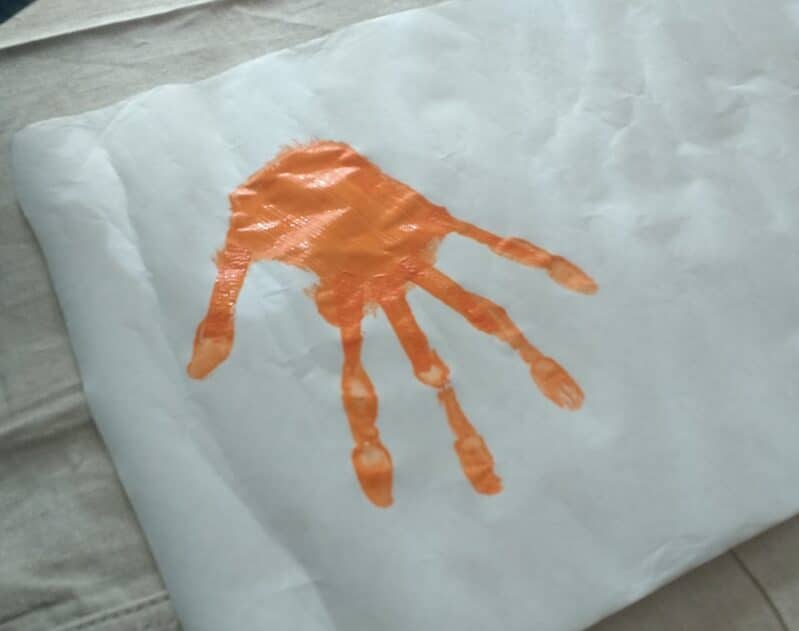 handprint filled in with paint to make a monster
