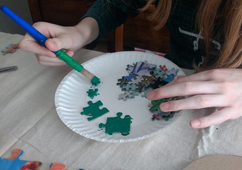 Painting puzzle pieces for Christmas wreath
