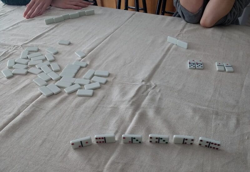 Playing a game of Go Fish with dominoes for children 