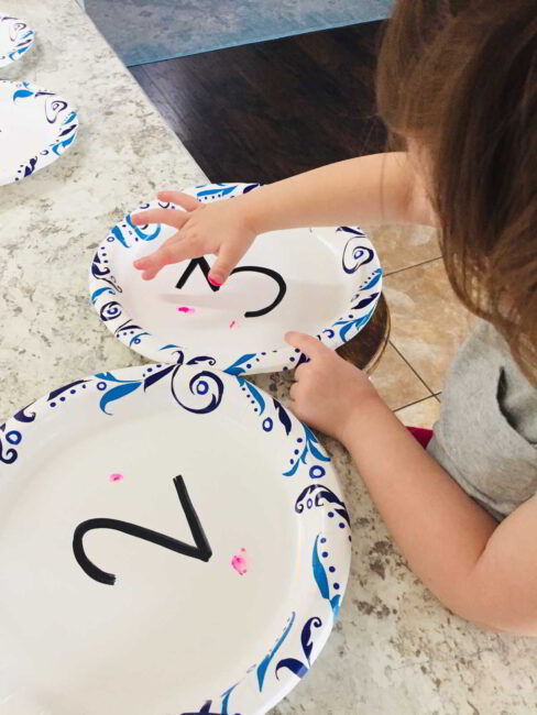Count on your hands and also with finger paints dabbing to match the number.