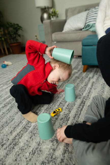 Encourage cognitive development in toddlers with this fun, no-prep, and simple toy and cup memory game that using supplies you have at home.