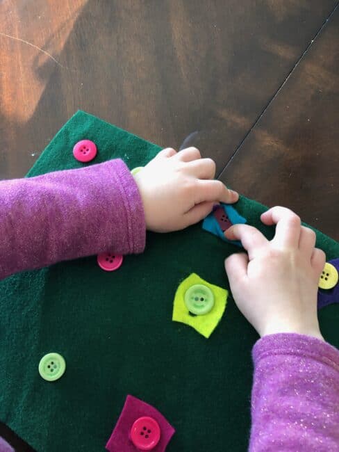 Work on the important dexterity life skill of buttoning with this easy no-see button board fine motor activity for toddlers and preschooler.