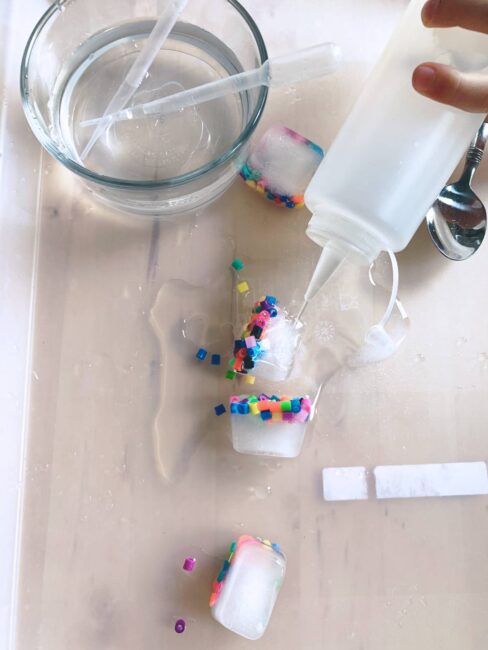 Easy prep stringing beads activity with ice that helps kids slow down and cool down while improving fine motor skills at home using just water, beads, pipe cleaners and household items.