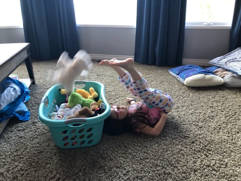 Transfer soft toys (teddy bears or other stuffed animals work great) from the floor over your body and into the laundry hamper.