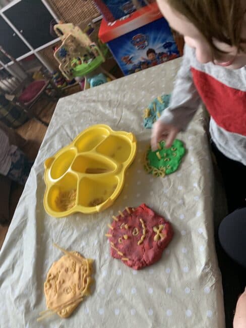 Making family portraits with play dough and pasta!