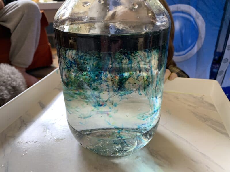Create a galaxy of shooting stars in a jar space experiment for kids to do at home using simple household supplies from the kitchen!