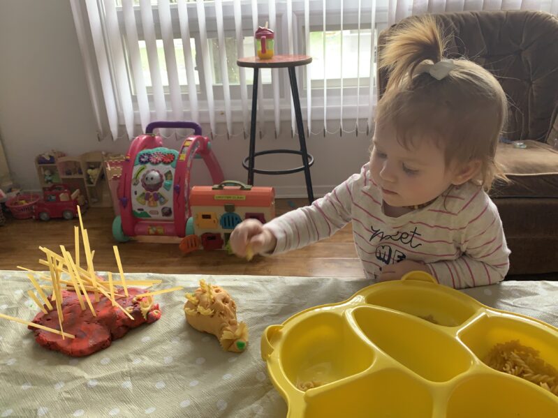 Making play dough and pasta porcupines with toddlers at home for hands on fine motor skills learning.