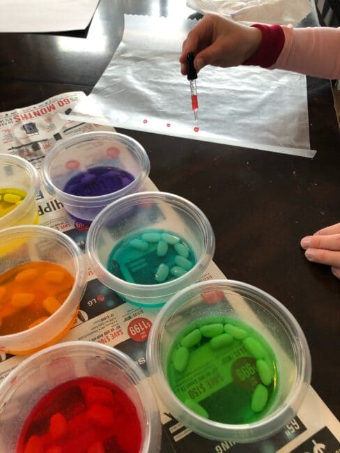 drop painting with jelly bean colored water onto wax paper